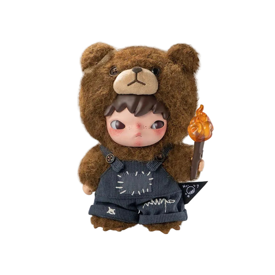 Toy figure of a character in a bear costume holding a torch on a white background